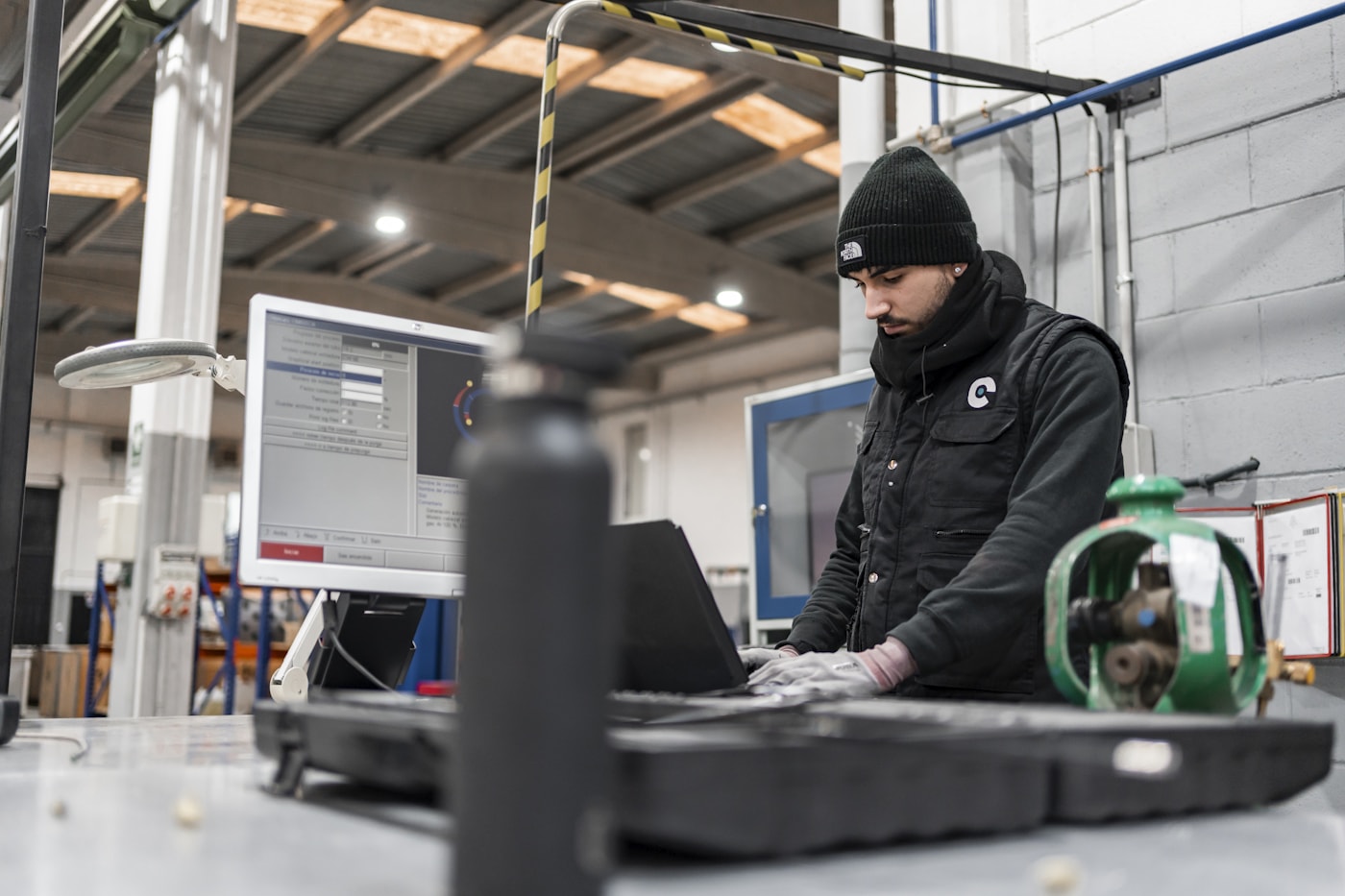 Technician using diagnostic software at an industrial workstation